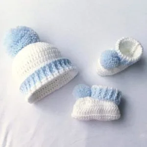 Light blue and white Crochet Baby Boy Booties & Cap Set with fluffy pom poms